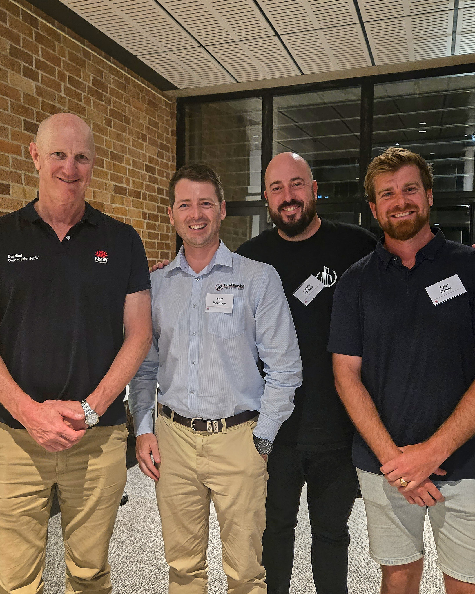 Four men in a group photo, 3 Building Certifiers with the NSW Building commissioner at an industry event at Newcastle Uni in Newcastle NSW