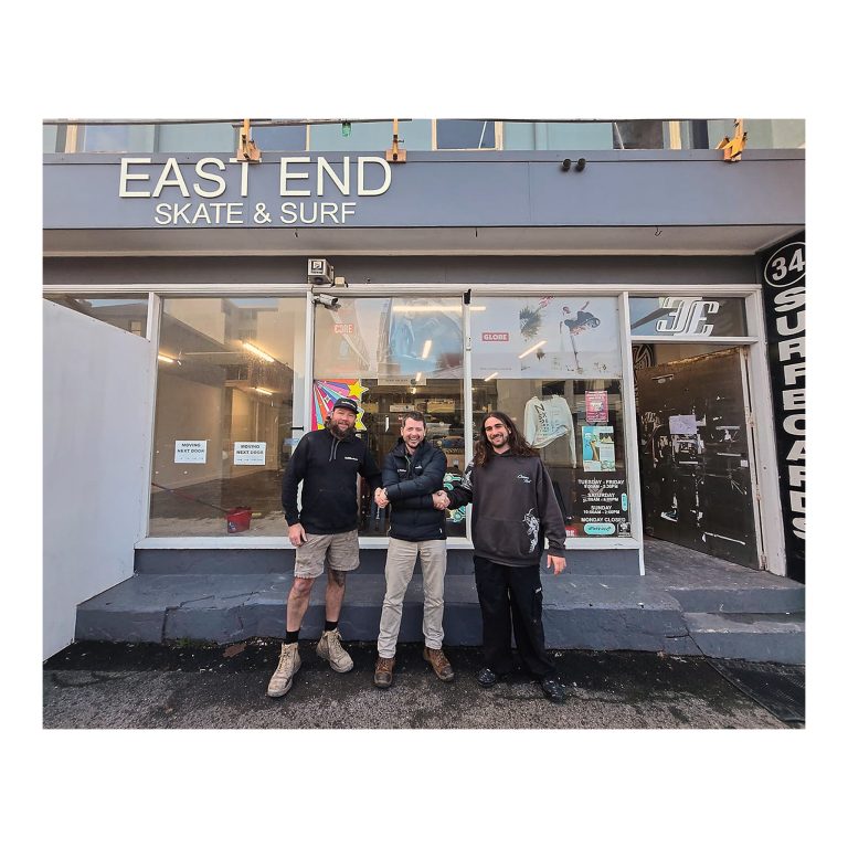 Kurt Moroney, centre, shaking hands simultaneously with Scott from Build Culture, left, and Aiden from East End Skate & Surf (right), out the front of the reopened shop, Newcastle NSW.