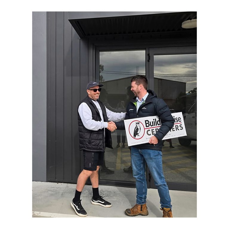 Kurt Moroney from Buildingwise Certifiers with Daniel Deane Zephyr Projects in front of Zephyr Projects signage Cardiff NSW. 3 of 4.