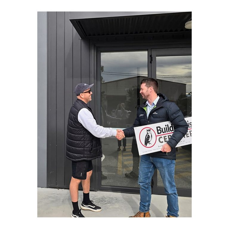 Kurt Moroney from Buildingwise Certifiers with Daniel Deane Zephyr Projects in front of Zephyr Projects signage Cardiff NSW. 3 of 4.