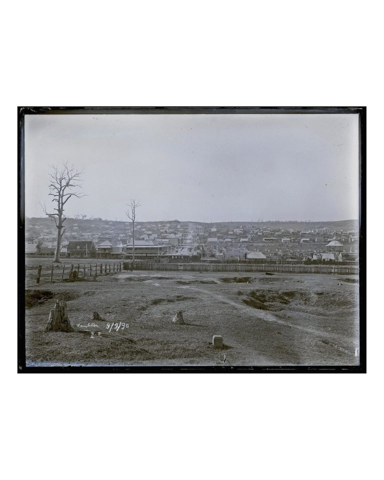 Historical black and white photograph by Ralph Snowball dated September 9, 1890, showing a wide landscape view of Lambton with a steam tram, corner hotel, houses, and rotunda in Lambton Park on the right.